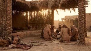 A serene scene evoking the Prophet's mosque in early Madinah with the Suffah platform area where the Companions gathered to learn